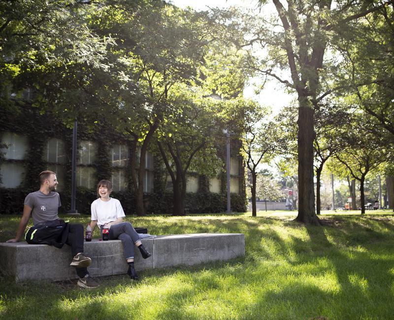 Students hang out on a pretty summer day